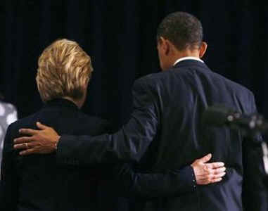Hillary Clinton and Barack Obama walk away from the podium arm-in-arm after Obama announces National Security Team on December 1st, 2008 in Chicago.