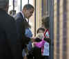Barack Obama greets school children across from his motorcade in Philadelphia on December 2, 2008.