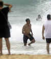 Barack Obama strolls on an Hawaiin beach on August 14, 2008. Obama's sports and activities are reflected in photos from the early years to the Presidency.