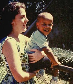 Barack Obama sits on the fence while held by his mother, Ann Dunham in Honolulu. Undated photo is circa 1960s. Anne Dunham was born in Kansas and moved to Hawaii prior to Obama's birth.