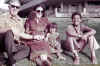 Barack Obama in Hawai with his mother Ann Dunham, his grandfather, and his sister. Barack Obama family photo circa 1970s.