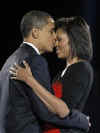 Barack Obama kisses Michelle after delivering a memorable and historic speech in front of a huge Chicago crowd and a worldwide TV audience on November 4, 2008.