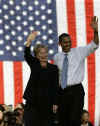Former Democratic rivals Barack Obama and Hillary Clinton arrive arm-in-arm waving to supporters at a campaign rally in Orlando Florida on October 20, 2008.