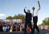 Barack Obama and Hillary Clinton arrive arm-in-arm waving to supporters at a campaign rally in Orlando Florida on October 20, 2008.