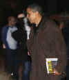 Barack Obama carries the book Lincoln: Biography of a Writer after leaving a friend's house near his Chicago home on November 22, 2008.