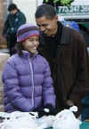 Barack and Malia Obama help at a Chicago school food bank on November 26, 2008.
