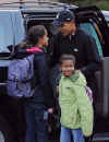 President-elect Barack Obama gives his daughters hugs and kisses after dropping them off at school before leaving for a visit to the White House on November 10, 2008.