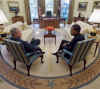 President George W. Bush and President-elect Barack Obama talk in the Oval Office of the White House on November 10, 2008.