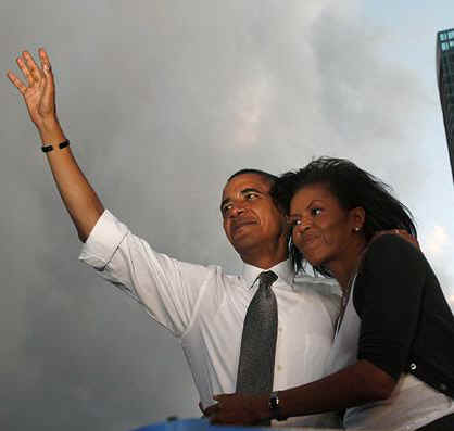 Michelle Obama hugs Barack at a presidential campaign rally at Bicentennial Park in Miami, Florida on October 21, 2008. 