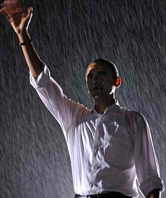 Obama waves to supporters at a university campaign rally in Washington, VA, on a wet September 27, 2008.