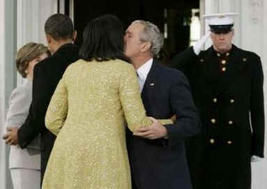 George W. Bush gives Michelle Obama a kiss at the South Portico of the White House prior to inauguration ceremonies.