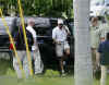 Barack Obama talks on the phone as he gets out of his SUV to play golf on December 21, 2008.