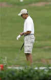 Obama adjusts his glove as he gets set to play golf in Kailua near his vacation home on December 21, 2008.