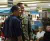 On December 25th Barack Obama pays a surprise visit to the Kailua Marine Corps Base during Christmas dinner.