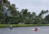 A kayaker and a stand-up paddler enjoy a Saturday afternoon in the canal near Barck Obama's beachfront vacation compound in Kailua, Hawaii on December 27, 2008.