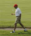 Barack Obama tosses his golf ball as he walks between holes at the Mid Pacific Country Club in Kailua, Hawaii on December 29, 2008.