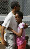 Barack Obama hugs his daughter Malia at the entrance to the Honolulu Zoo on December 30, 2008. Barack Obama went to the Honolulu Zoo with family and friends.