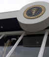 A worker washes the bullet proof windows of the Presidential review stand in preparation for the inauguration of President Barack Obama.