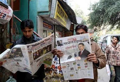 Readers at New Delhi, India newsstand. Barack Obama's presidential inauguration dominates international newsstands.