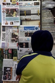 Reader in Beirut, Lebanon. Barack Obama's presidential inauguration dominates international newsstands.
