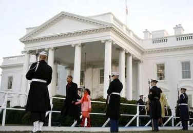 The presidential family arrives at the reviewing stand in front of the White House to watch the Inaugural Parade.