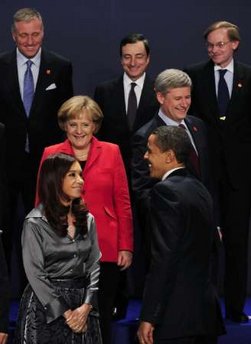 President Obama walked on the stage and walked directly to PM Harper to tease him about his absence from the original group photo.