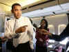 President Barack Obama talks to reporters in the press cabin of Air Force One.