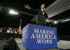 President Barack Obama is welcomed to the stage of the Harborside Event Center in Fort Meyers, Florida by Florida Governor Charlie Crist on February 10, 2009. President Obama spoke to the crowd then answered questions.