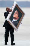 White House military staff unloads Obama portrait from Air Force One at Andrews AFB.