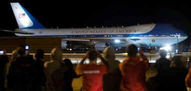 Air Force One with President Barack Obama aboard taxis at Abraham Lincoln Capital Airport in Springfield, Illinois while onlookers snap photos.
