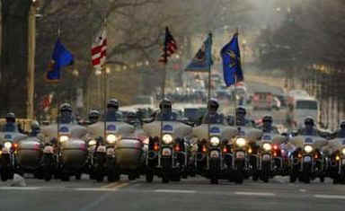 A Police Motorcycle Escort Group rumbles down Pennsylvania Avenue as the Inaugural Parade proceeds to the White House.