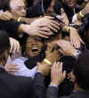 Hands of supporters cover Barack Obama after his Primary Election Night Speech in St. Paul, Minnesota on June 3, 2008.