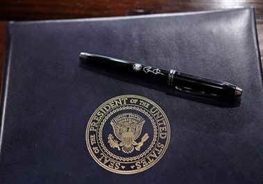 With a custom signature pen President Barack Obama signs several Executive Orders and administration gets sworn in at White House senior staff meeting. The President's first staff meetings and take place on the White House campus at the Eisenhower Executive Office Building.
