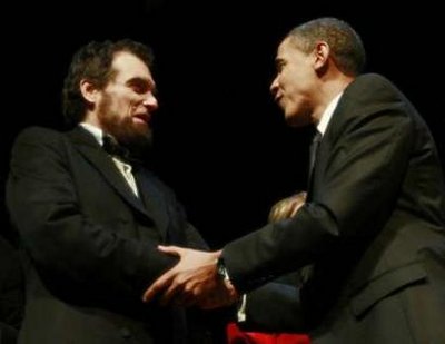 President Barack Obama and First Lady Michelle Obama attend the Grand Re-Opening of Ford's Theatre in Washington on February 11, 2009. President Obama meets a Lincoln actor (photo), receives a copy of the Gettysburg Address, and speaks just below the box where President Abraham Lincoln was shot.