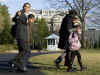 President Barack Obama and his family walk across the South Lawn of the White House to Marine One.