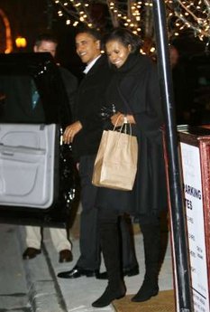 President Barack Obama and First Lady Michelle Obama leave Table 52 restaurant after a Valentine's Day dinner in Chicago.