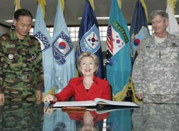 Secretary of State Clinton signs Guest Book with the Commander of US Forces for South Korea General Walter Sharp (right) at Yongsan Garrison in Seoul, South Korea