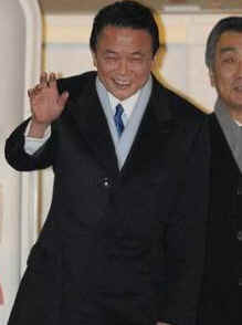 Japan's PM Taro Aso waves as he departs Tokyo for Andrews Air Force Base on February 23, 2009.