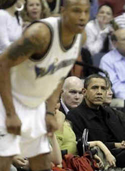 President Obama and his friend Marty Nesbitt watch the NBA match between the Washington Wizards and the Chicago Bulls at the Verizon Center in Washington. Obama is a Bulls fan, however the Wizards won the game 113-90.