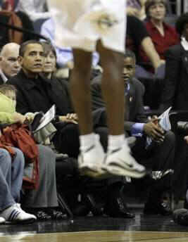 President Obama and his friend Marty Nesbitt watch the NBA match between the Washington Wizards and the Chicago Bulls at the Verizon Center in Washington. Obama is a Bulls fan, however the Wizards won the game 113-90.