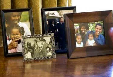 Over the February 1st 2009 weekend President Obama personalizes the Oval Office with family photographs placed on the credenza behind Obama's desk.