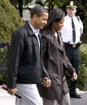 President Barack Obama and First Lady Michelle Obama walk across the South Lawn of the White House holding hands as they depart for an overnight stay with family at the presidential retreat at Camp David on March 7, 2009.