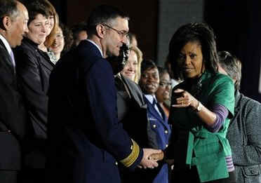 First Lady Michelle Obama greets attendeees before speaking at the Department of Homeland Security