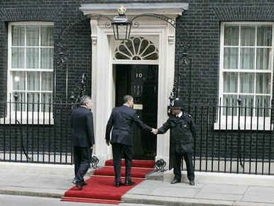 President Obama shakes the hand of a London police officer as he returns to the Downing Street residence.