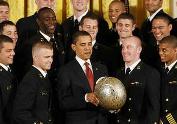 President Barack Obama presents the Commander In Chief Trophy to the Naval Academy Football Team in the East Room of the White House.