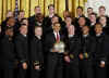 President Barack Obama presents the Commander In Chief Trophy to the Naval Academy Football Team in the East Room of the White House.