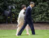 President Obama walks to the Oval Office with Senior Adviser Valerie Jarrett.
