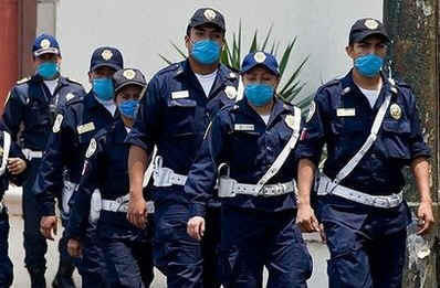 Mexican police wear protective masks in Mexico City on April 27, 2009.