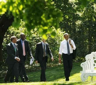 After greeting guests at the ceremony President Obama,  followed by White House aides, walked across the South Lawn to the Oval Office.