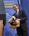 President Obama is introduced by FBI Director Robert Mueller who gives Obama two teddy bears for daughters Sasha and Malia.
